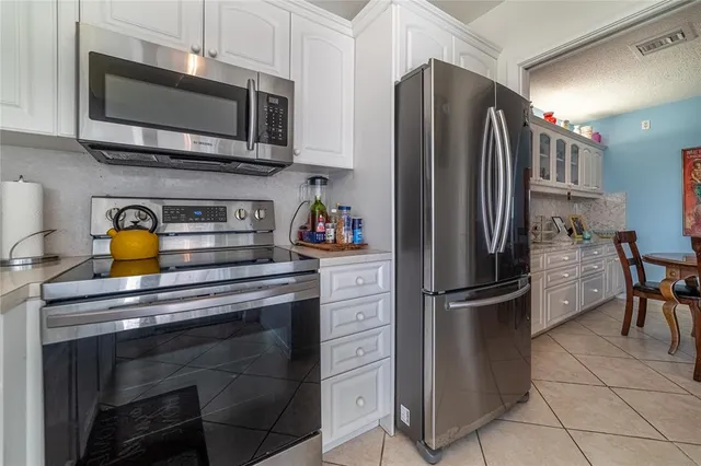 a kitchen with appliances a sink and cabinets