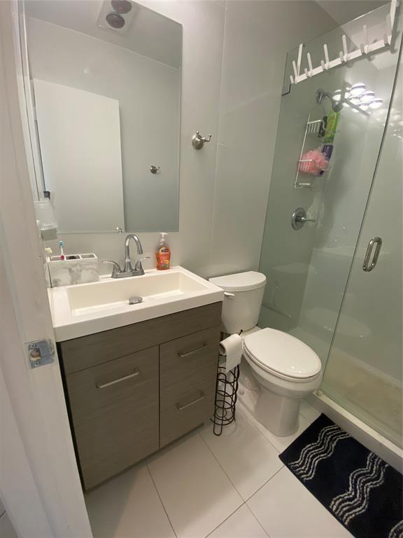 2100 Northeast 38th Street, Unit 216 Lighthouse Point, FL 33064 - Photo 10 of 27 a bathroom with a sink mirror vanity and toilet
