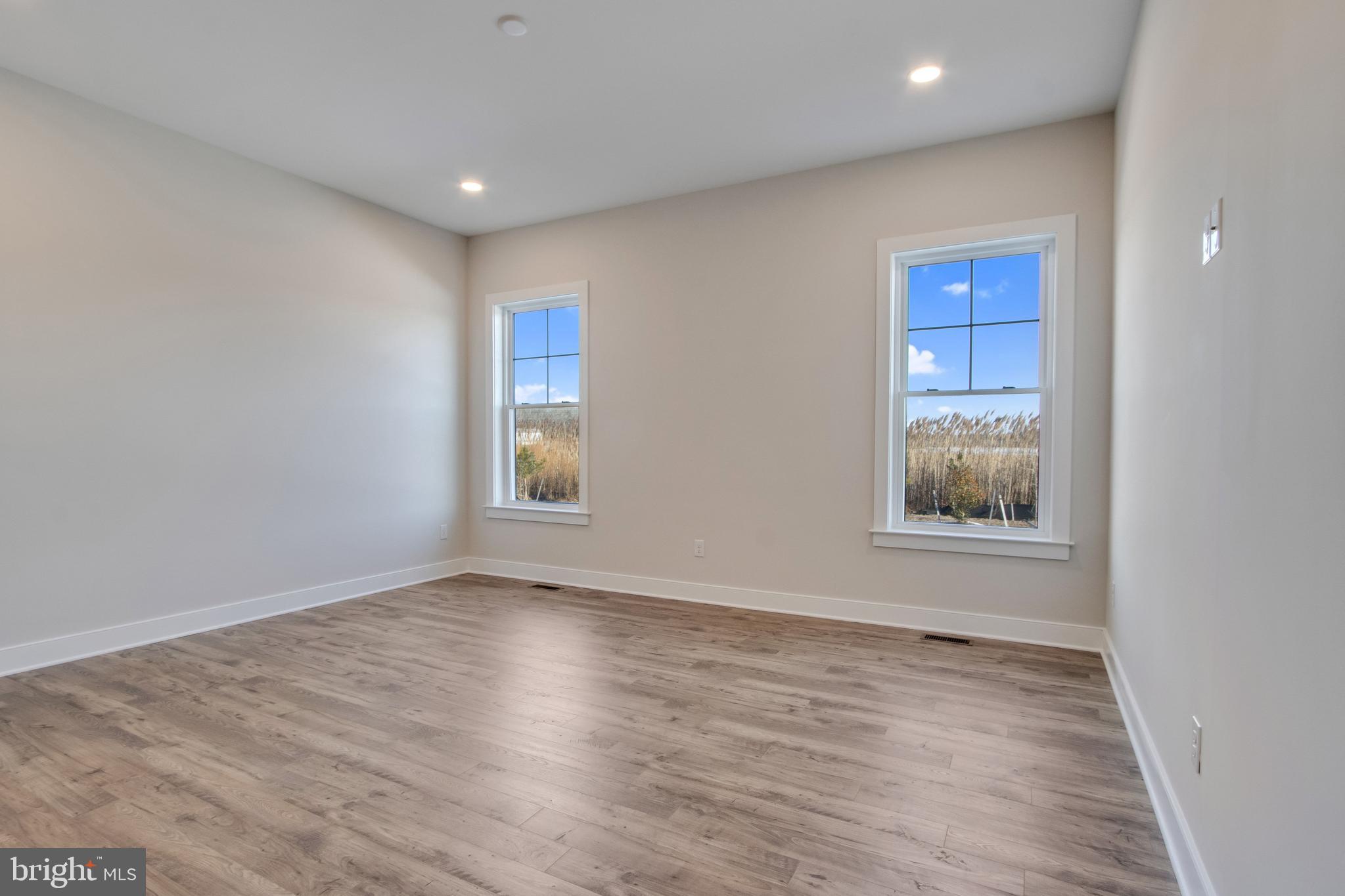 30491 Blue Beech Lane Frankford, DE 19945 - Photo 33 of 73 a view of an empty room with wooden floor and a window