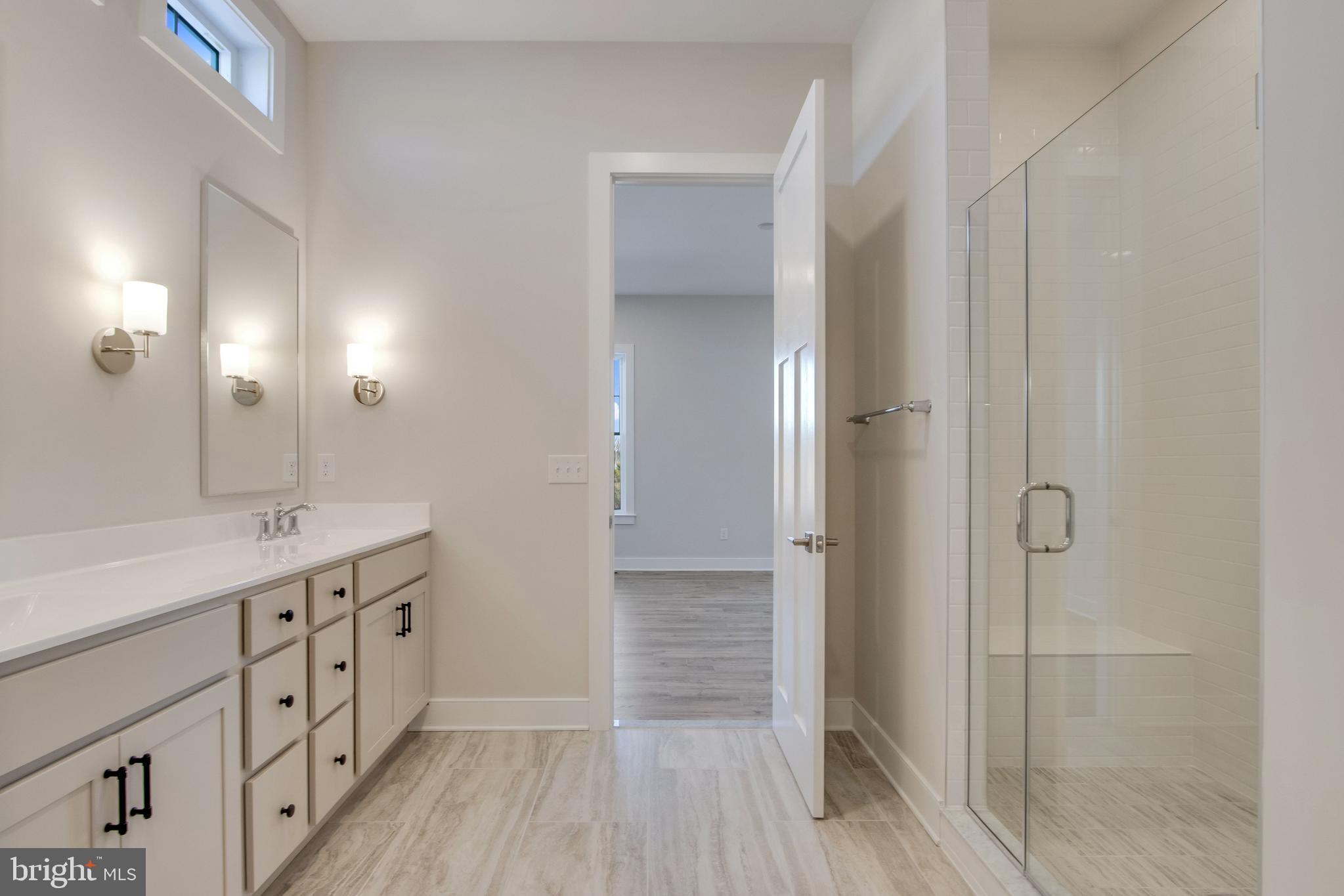 30491 Blue Beech Lane Frankford, DE 19945 - Photo 36 of 73 a bathroom with a double vanity sink and a mirror