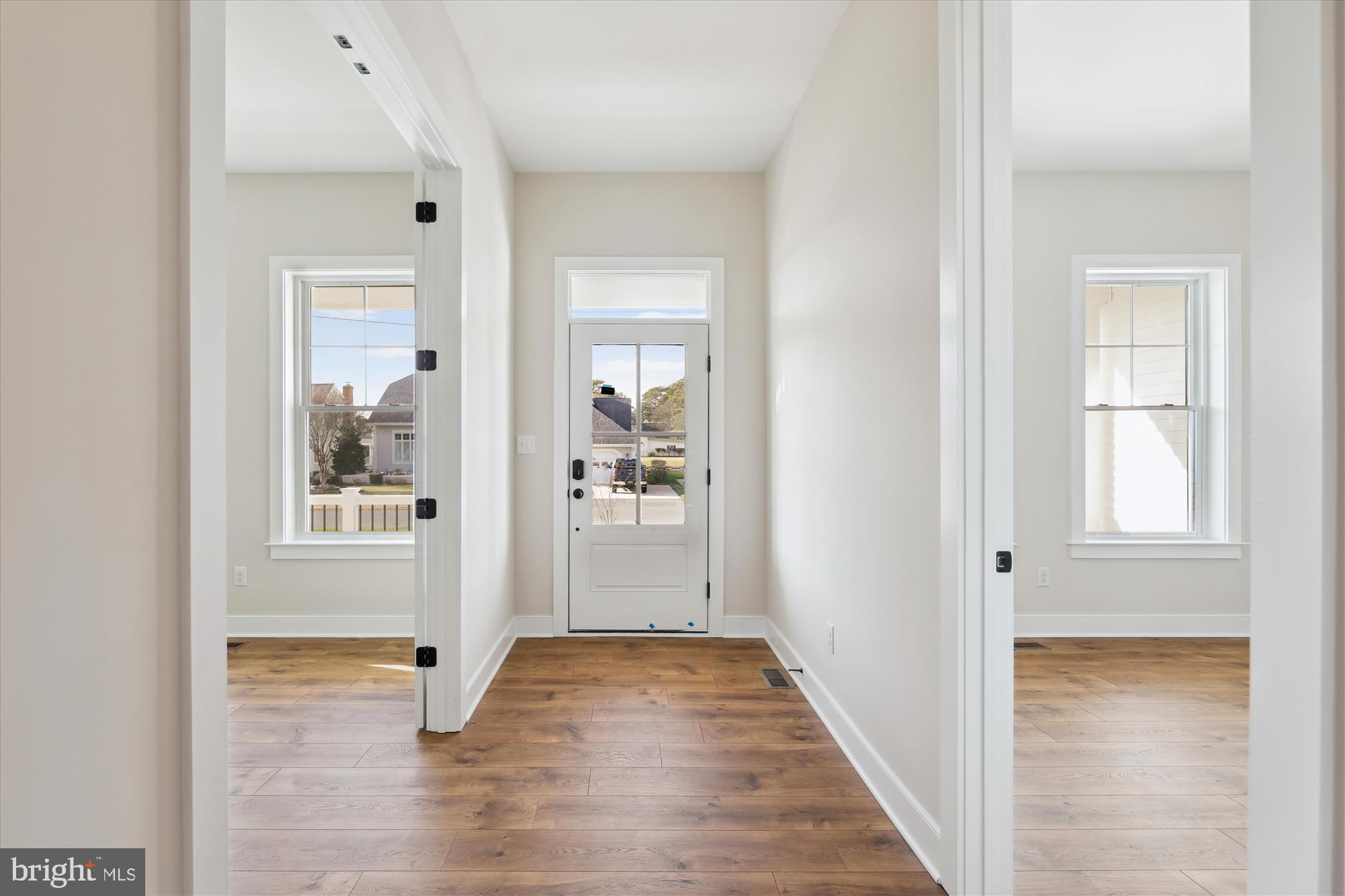 30491 Blue Beech Lane Frankford, DE 19945 - Photo 10 of 13 a view of a hallway with wooden floor and a bathroom
