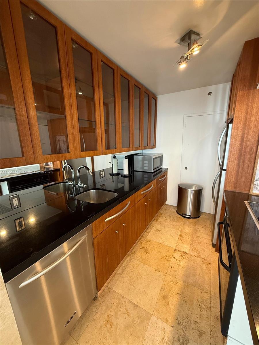 100 Lincoln Road, Unit 1111 Miami Beach, FL 33139 - Photo 11 of 30 a kitchen with stainless steel appliances granite countertop a sink stove and cabinets