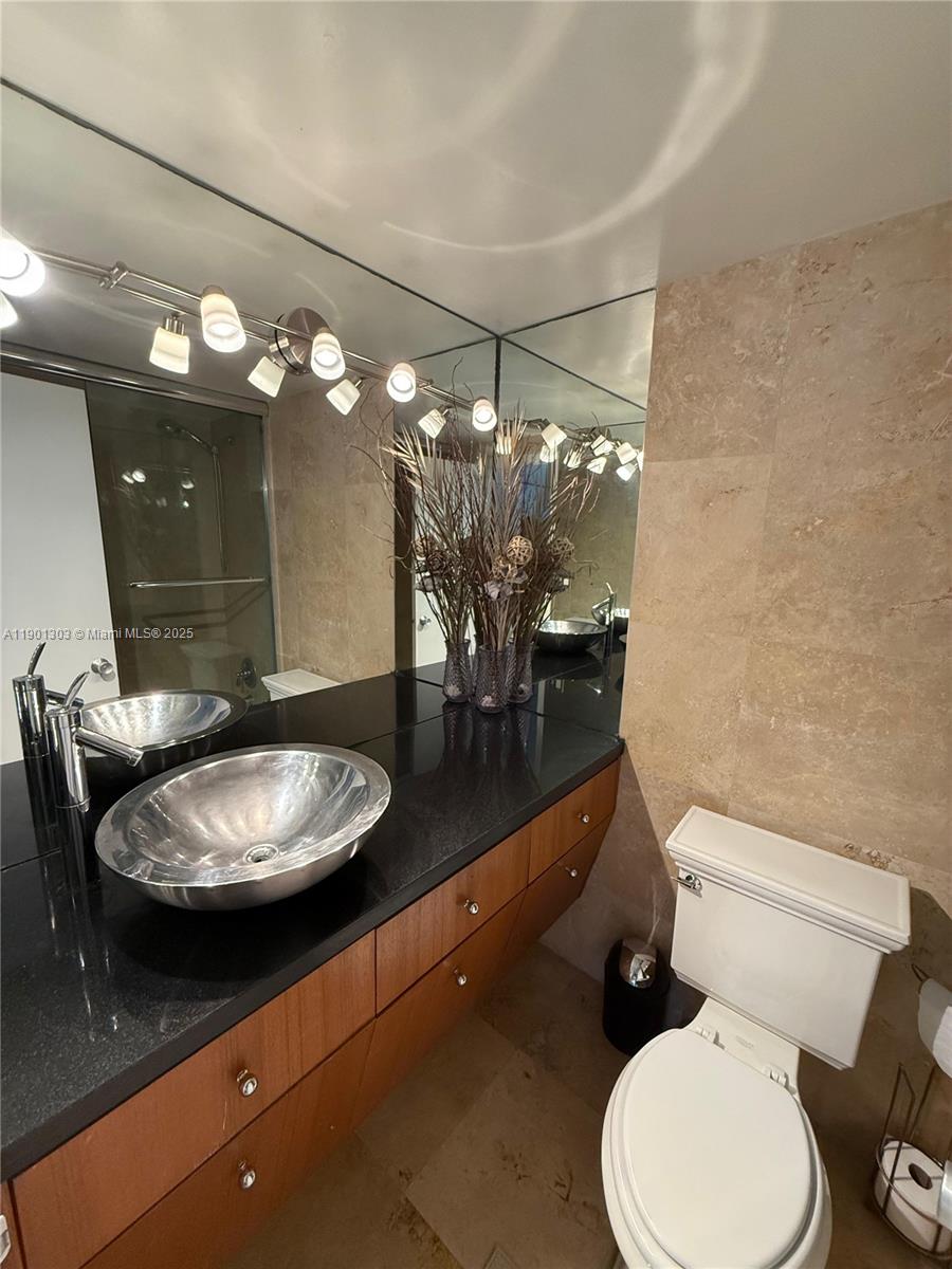 100 Lincoln Road, Unit 1111 Miami Beach, FL 33139 - Photo 13 of 30 a bathroom with a toilet a sink and view of a mirror