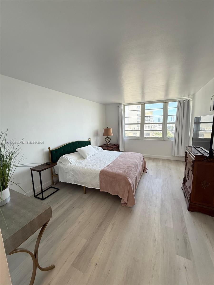 100 Lincoln Road, Unit 1111 Miami Beach, FL 33139 - Photo 5 of 30 a bedroom with a bed flat screen tv on desk and a window