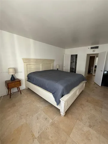 a bedroom with a bed and a table