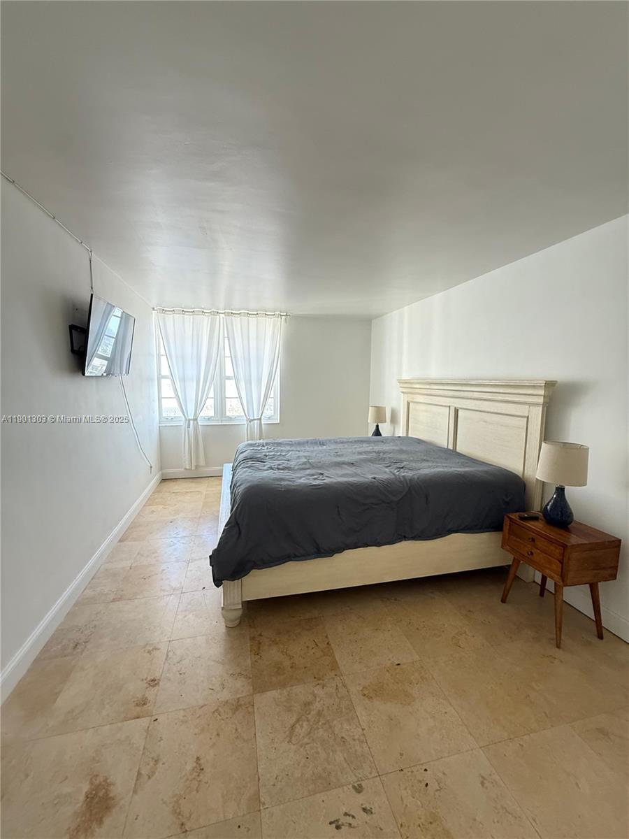 100 Lincoln Road, Unit 1111 Miami Beach, FL 33139 - Photo 8 of 30 a bedroom with a bed and chair