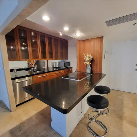 a kitchen with stainless steel appliances granite countertop a sink stove and cabinets