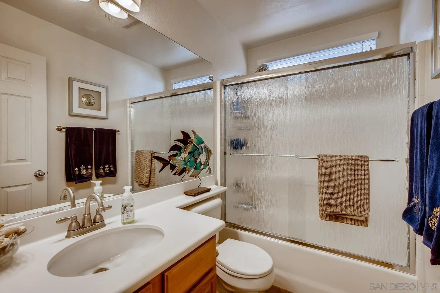 1332 Enchante Way Oceanside, CA 92056 - Photo 12 of 28 a bathroom with a sink toilet and shower