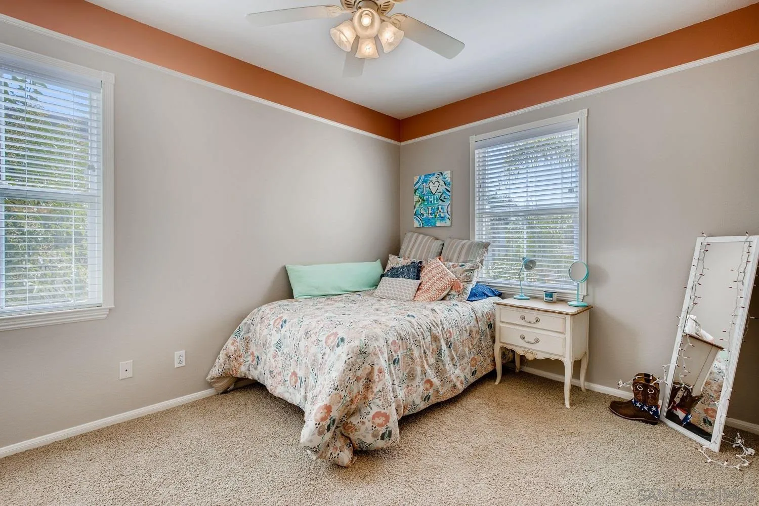 1332 Enchante Way Oceanside, CA 92056 - Photo 20 of 28 a bedroom with a bed and a chandelier