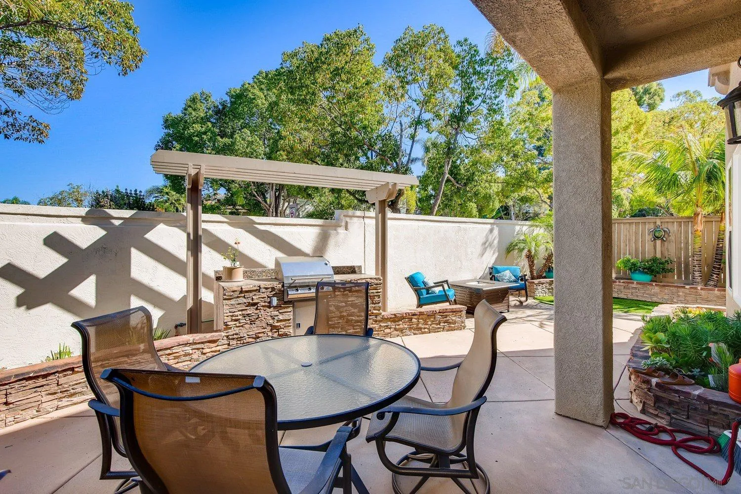 1332 Enchante Way Oceanside, CA 92056 - Photo 24 of 28 a patio with table and chairs and potted plants