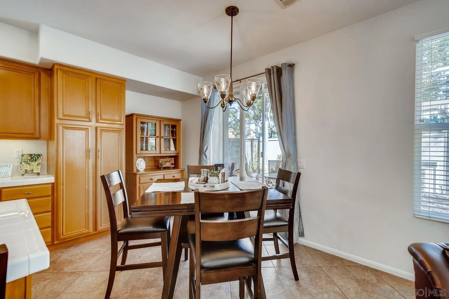 1332 Enchante Way Oceanside, CA 92056 - Photo 5 of 28 a dining room with furniture a chandelier and window