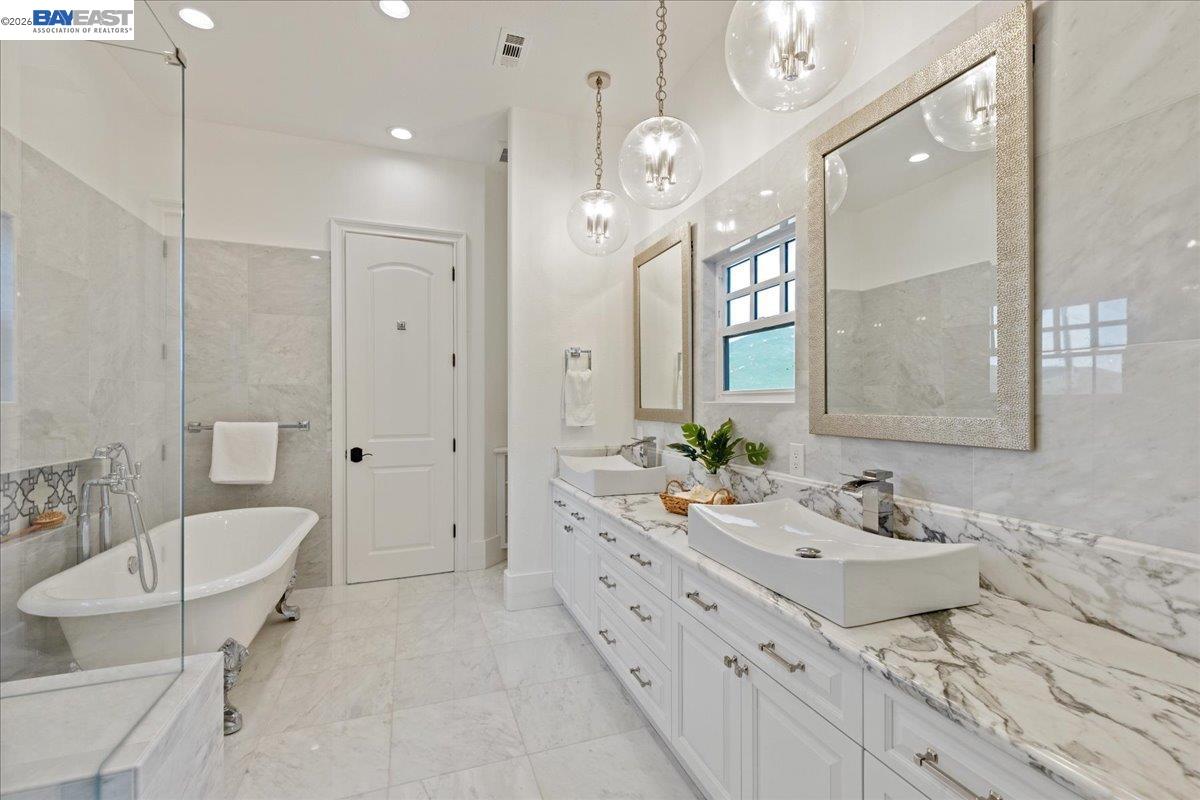 12400 Morgan Territory Road Livermore, CA 94551 - Photo 29 of 59 a spacious bathroom with a double vanity sink mirror and bathtub