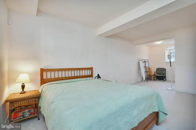 a bedroom with a bed and a view of bedroom