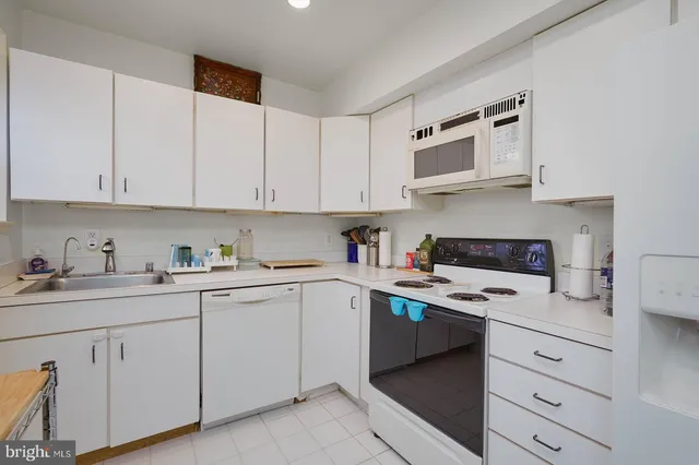 a kitchen with cabinets appliances cabinets and a sink