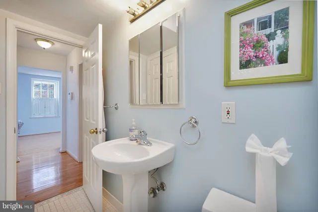 a bathroom with a sink and mirror with toilet