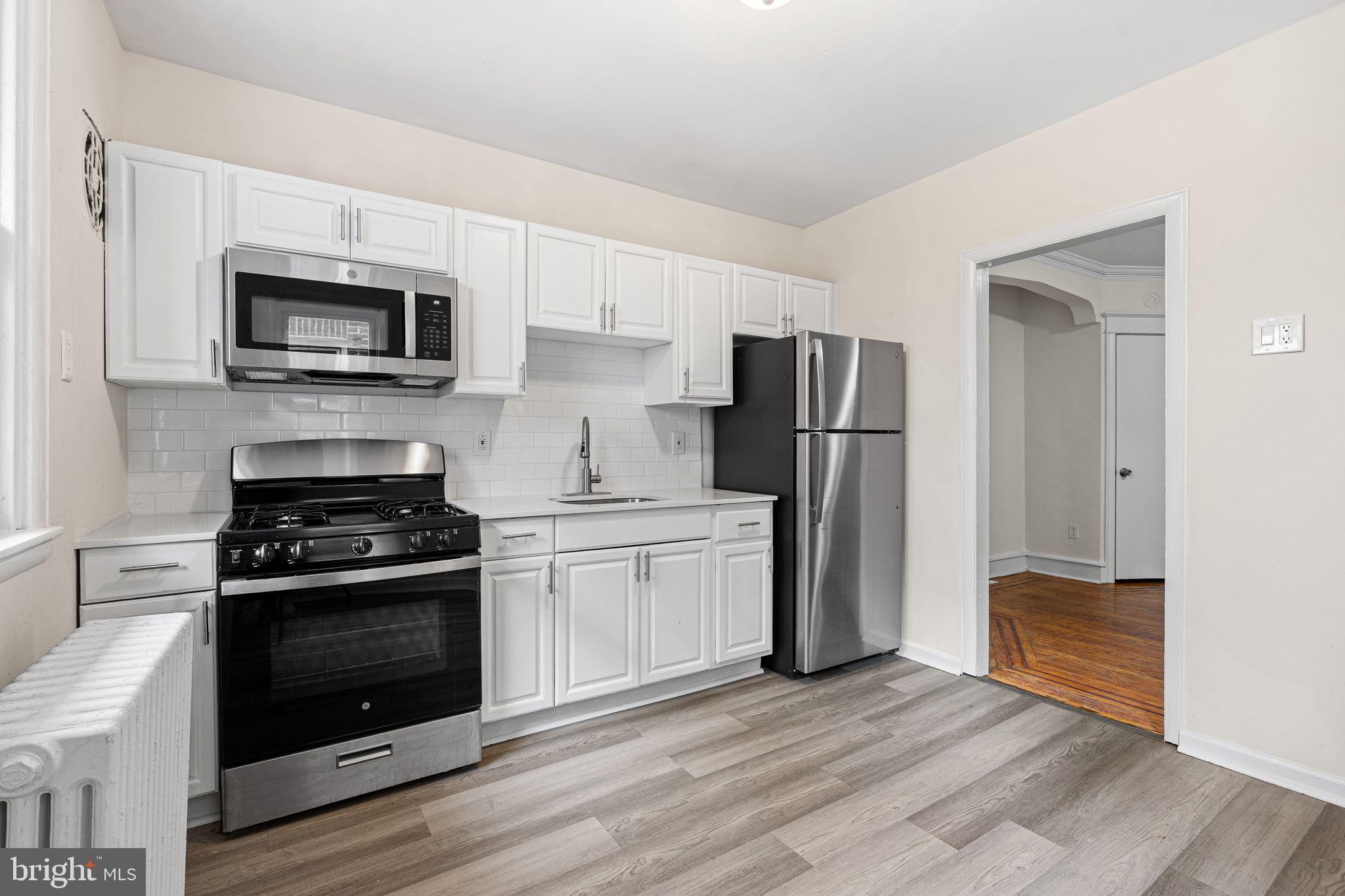 324 Kingston Road Upper Darby, PA 19082 - Photo 5 of 14 a kitchen with a stove a microwave and refrigerator