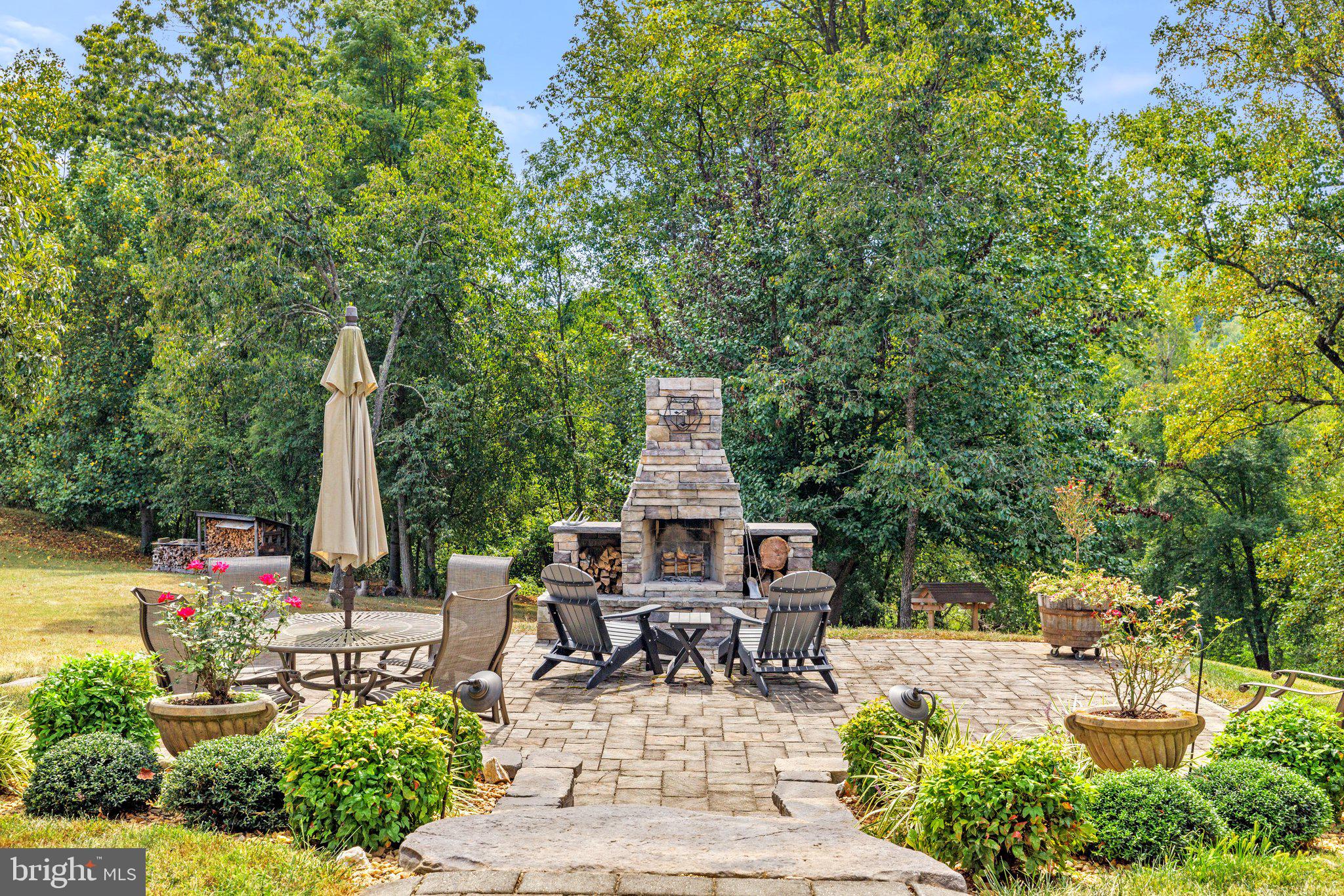 12147 Moss Hollow Road Markham, VA 22643 - Photo 32 of 46 Stone terrace with fireplace