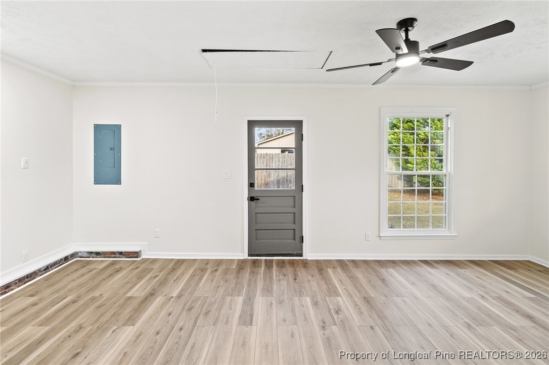 5982 Spinner Road Hope Mills, NC 28348 - Photo 13 of 32 a view of empty room with wooden floor and fan