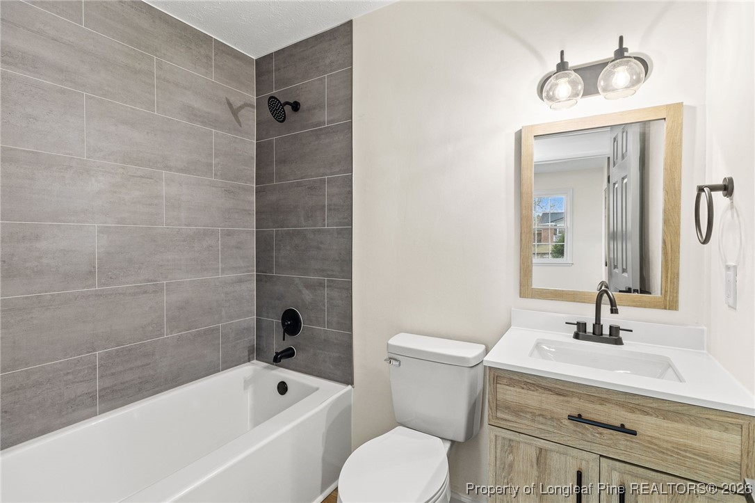 5982 Spinner Road Hope Mills, NC 28348 - Photo 16 of 32 a bathroom with a sink a toilet and shower
