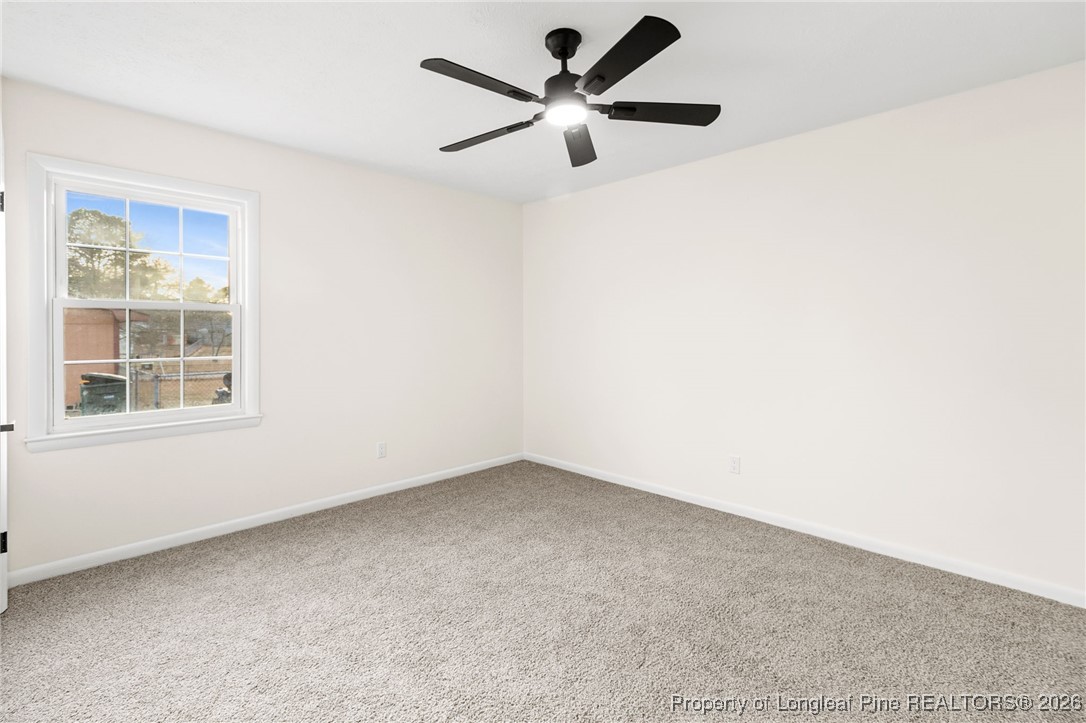 5982 Spinner Road Hope Mills, NC 28348 - Photo 18 of 32 an empty room with windows and fan