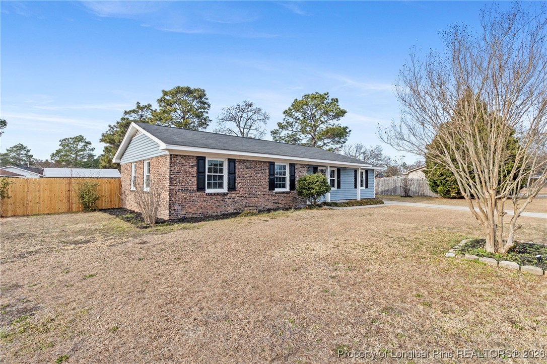 5982 Spinner Road Hope Mills, NC 28348 - Photo 2 of 32 a view of a house with a yard covered in snow