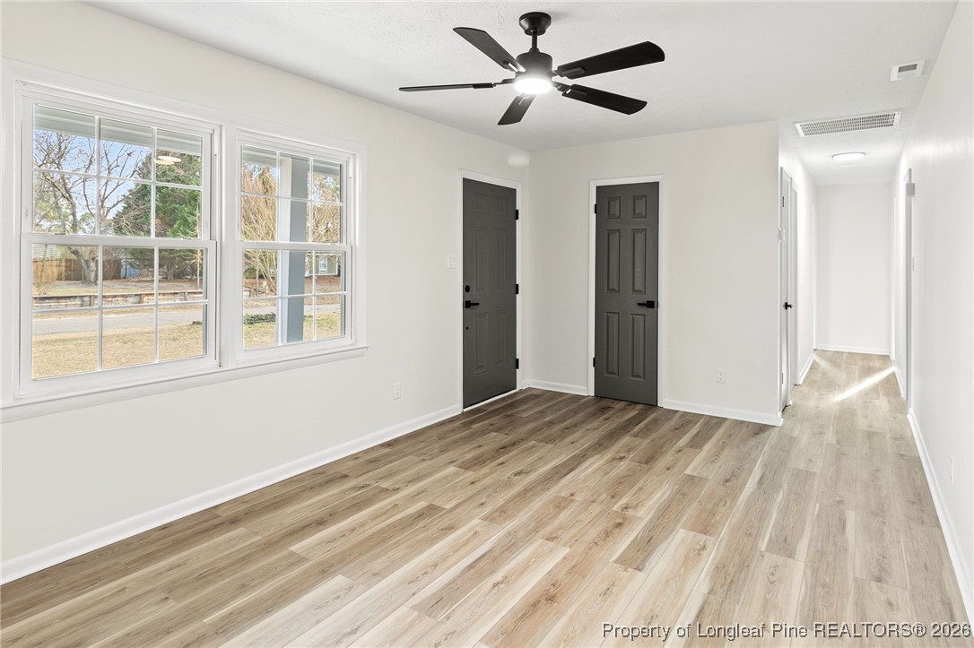5982 Spinner Road Hope Mills, NC 28348 - Photo 7 of 32 a view of empty room with wooden floor and fan