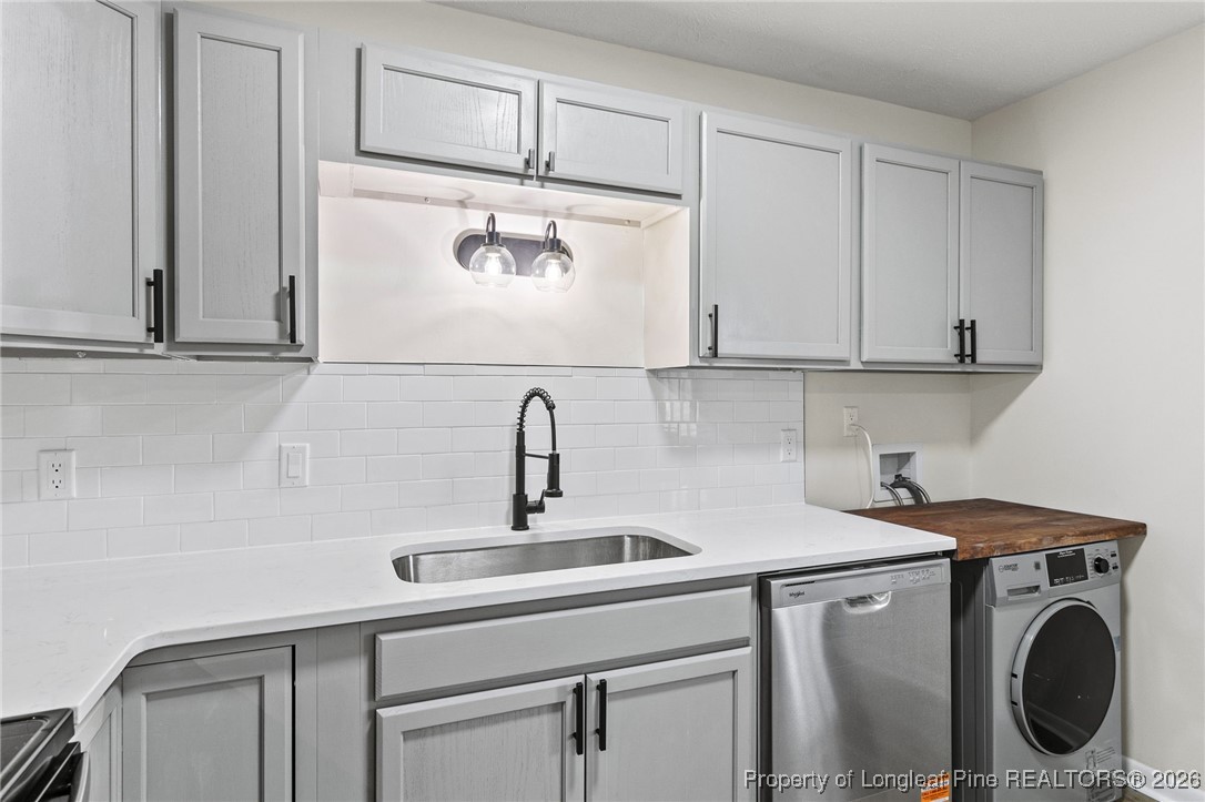 5982 Spinner Road Hope Mills, NC 28348 - Photo 10 of 32 a utility room with stainless steel appliances white cabinets and a sink