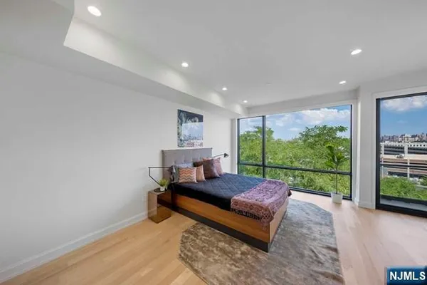 a bedroom with a bed and large window