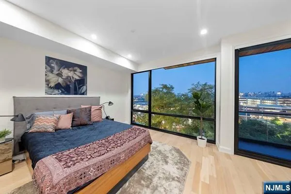 a bedroom with a large bed and a balcony view