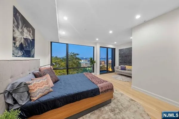 a living room with furniture and a floor to ceiling window