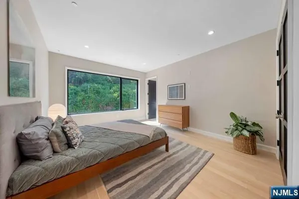 a bedroom with a bed potted plant with the window