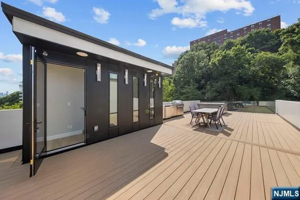 a roof deck with a table and chairs