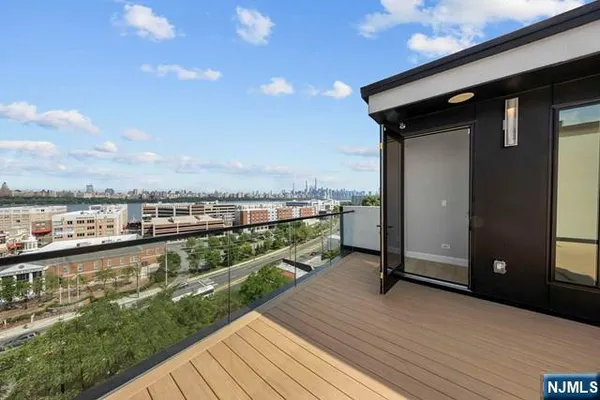 a view of a balcony with wooden floor
