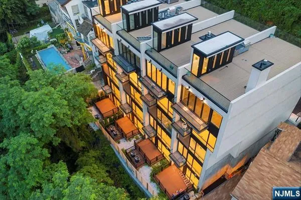 an aerial view of houses with backyard