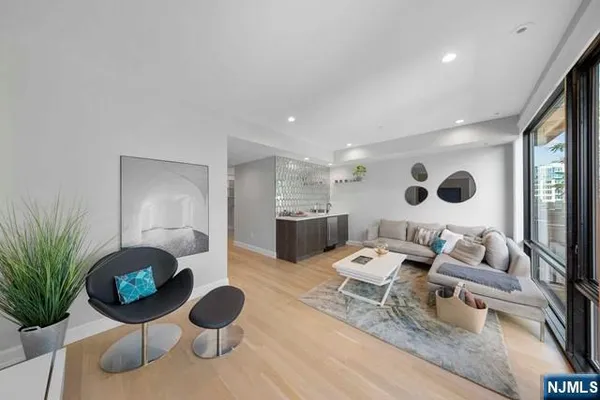 a living room with furniture and a mirror