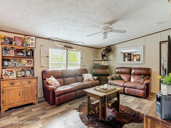 a living room with furniture and a book shelf