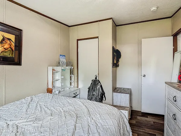 a bedroom with a bed and a mirror