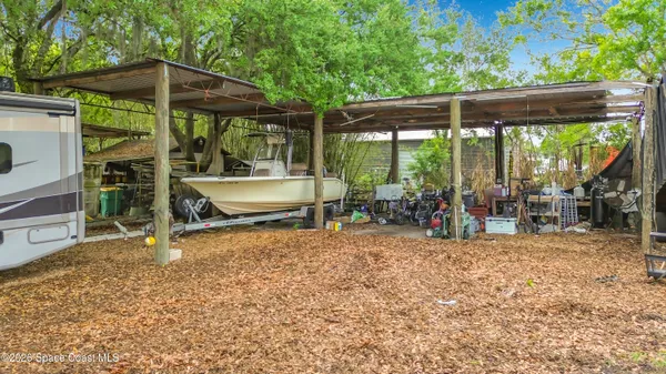 an aerial view of a residential houses with yard