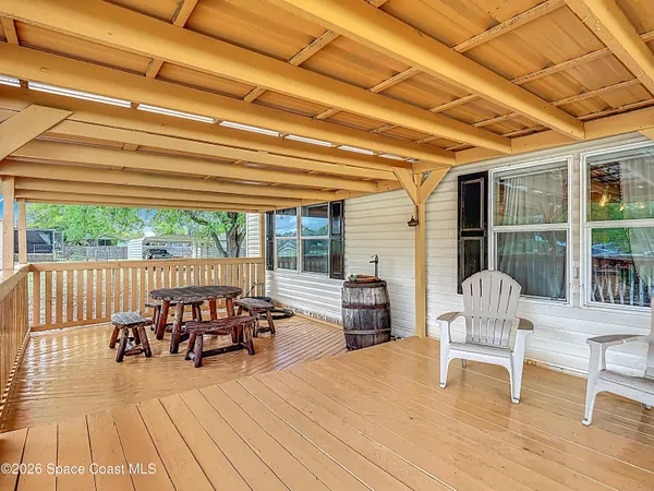 a balcony with furniture and wooden floor