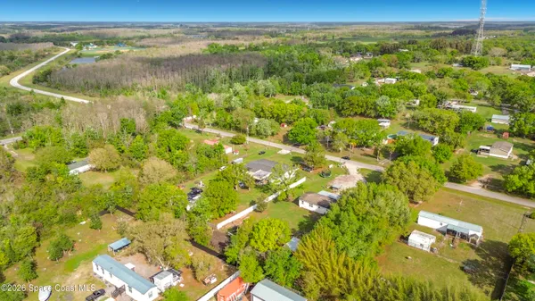 an aerial view of residential houses with outdoor space and street view