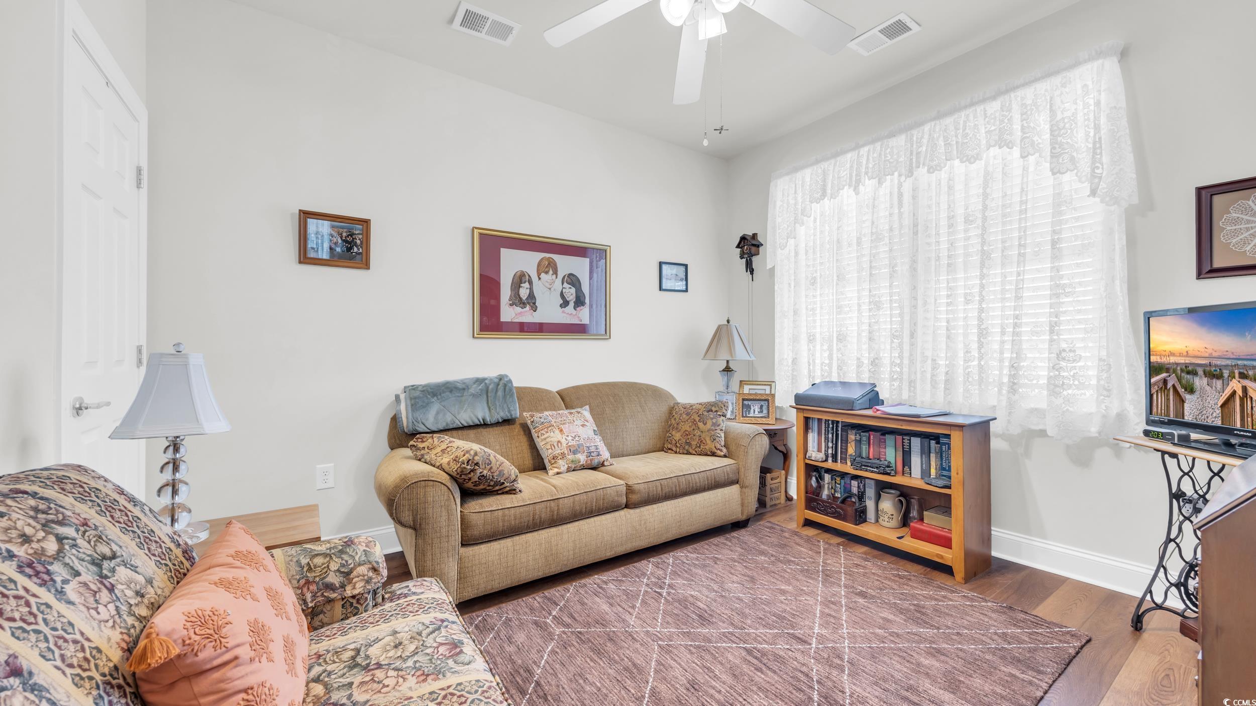 730 Pickering Drive, Unit 301 Murrells Inlet, SC 29576 - Photo 13 of 30 Living area featuring wood finished floors and a ceiling fan