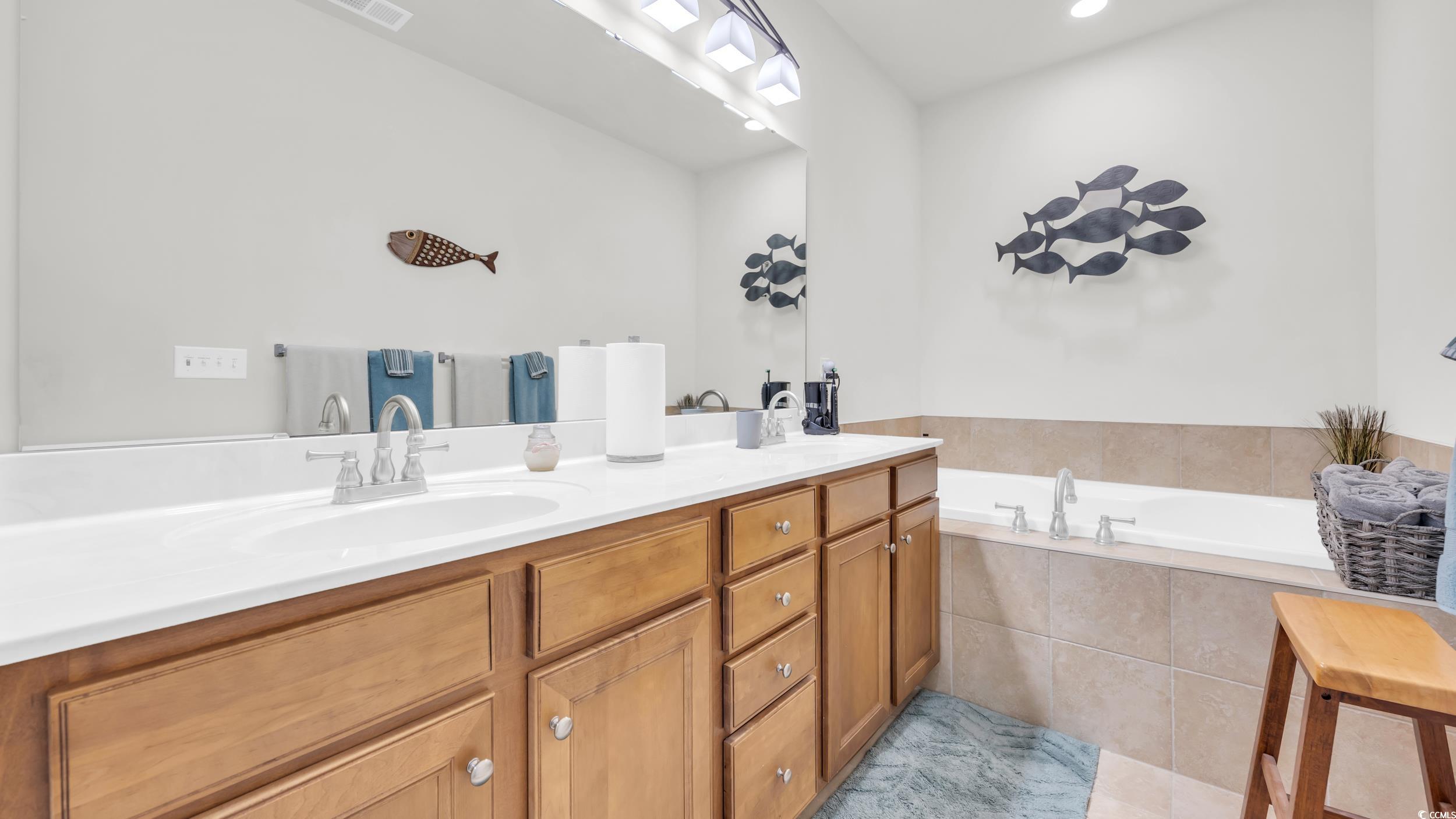 730 Pickering Drive, Unit 301 Murrells Inlet, SC 29576 - Photo 17 of 30 Bathroom with double vanity and a garden tub