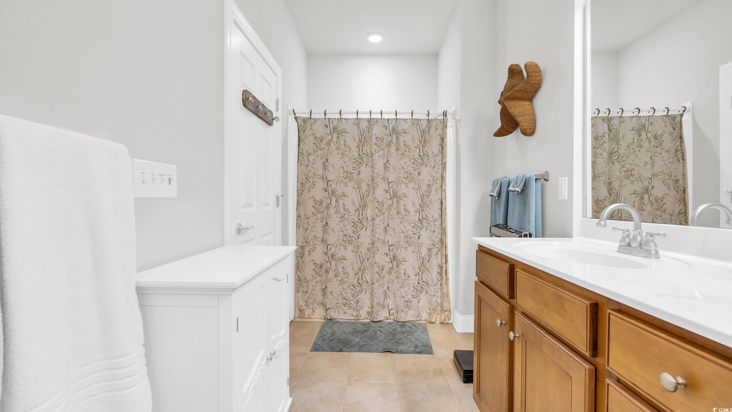 730 Pickering Drive, Unit 301 Murrells Inlet, SC 29576 - Photo 18 of 30 Bathroom featuring vanity, a shower with curtain, and light tile patterned floors