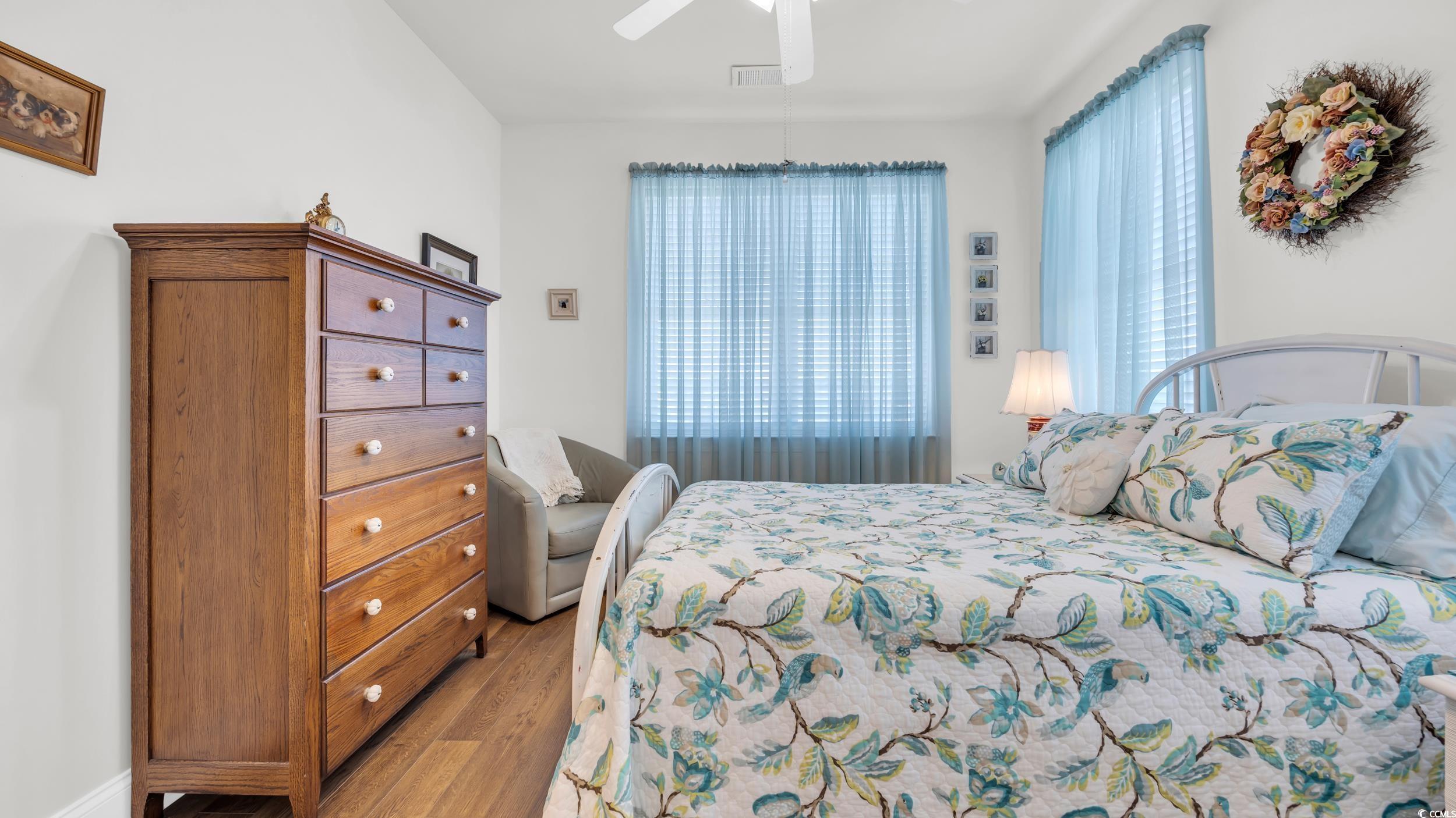 730 Pickering Drive, Unit 301 Murrells Inlet, SC 29576 - Photo 20 of 30 Bedroom featuring wood finished floors and a ceiling fan