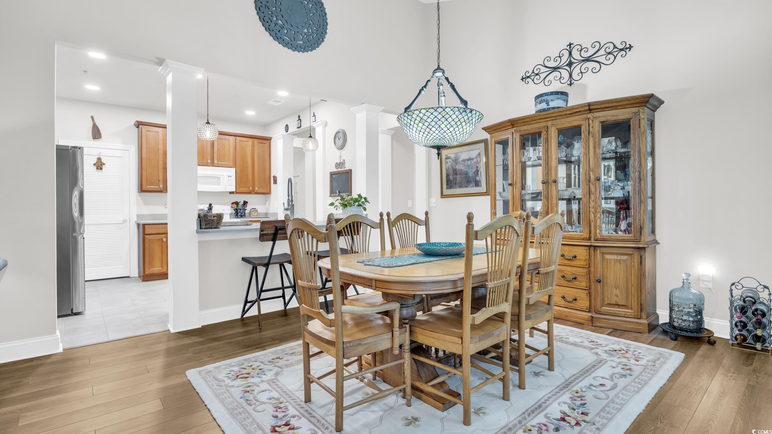 730 Pickering Drive, Unit 301 Murrells Inlet, SC 29576 - Photo 8 of 30 Dining room featuring dark wood-style floors, recessed lighting, and ornate columns