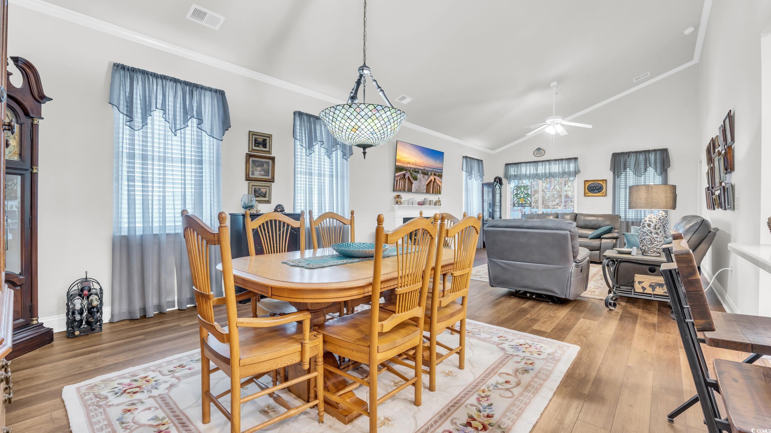 730 Pickering Drive, Unit 301 Murrells Inlet, SC 29576 - Photo 9 of 30 Dining room featuring crown molding, vaulted ceiling, light wood finished floors, and a ceiling fan