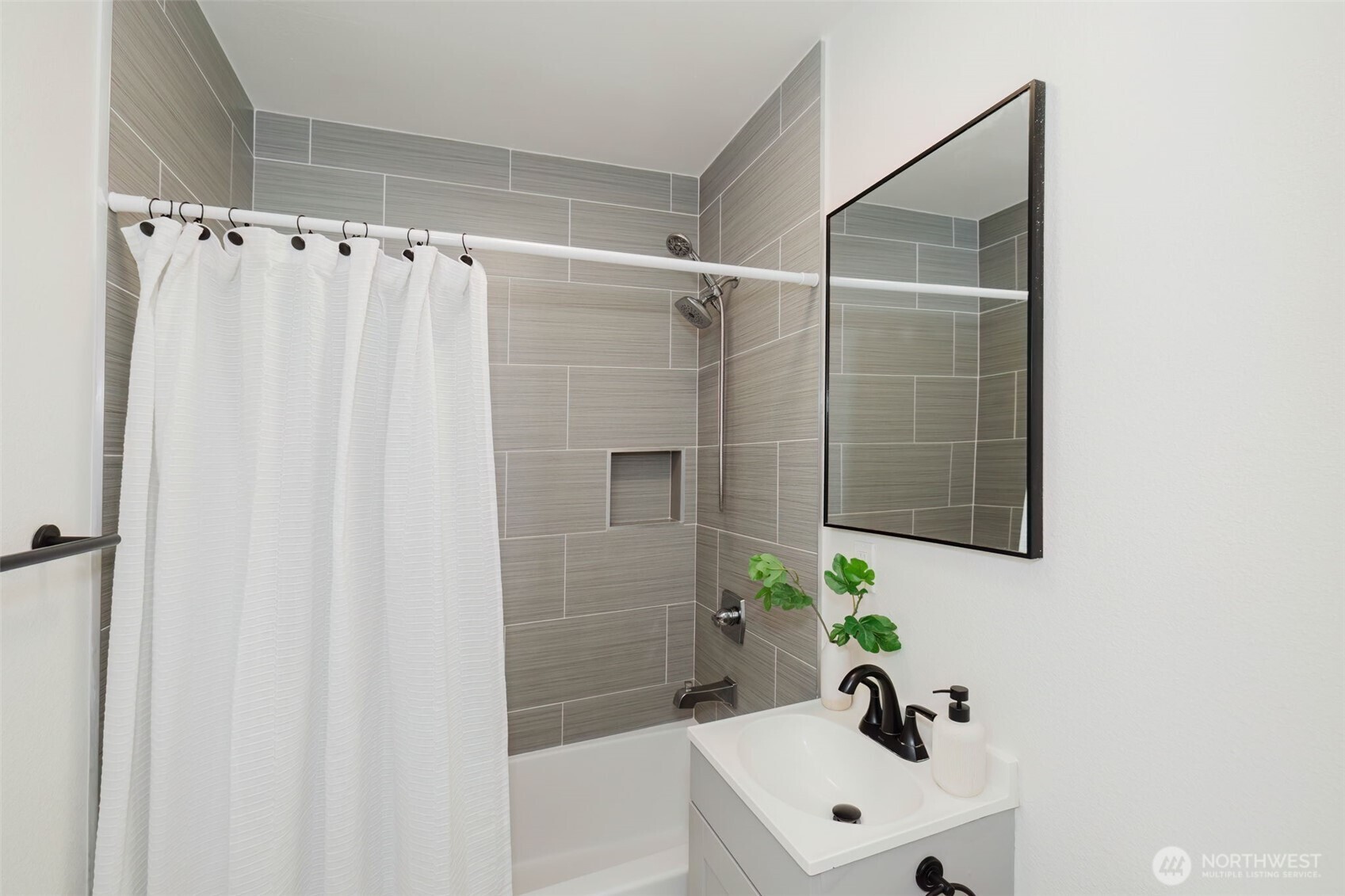 1540 7th Street Bremerton, WA 98337 - Photo 21 of 36 a bathroom with a shower curtain and a sink
