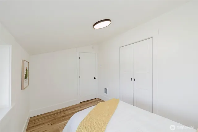 a bedroom with a bed and a lamp