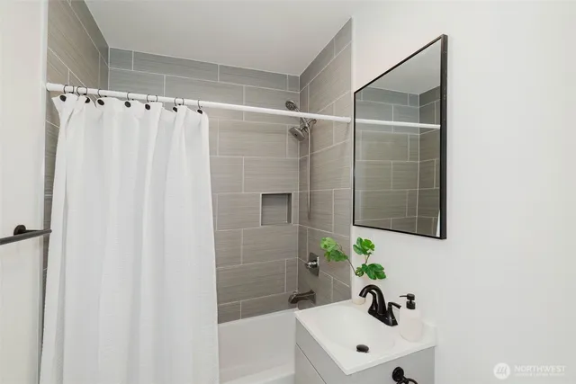 a bathroom with a shower curtain and a sink
