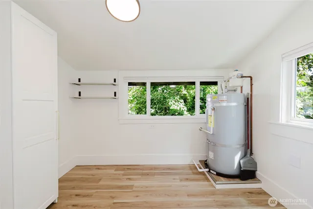 a view of a livingroom with wooden floor and a window